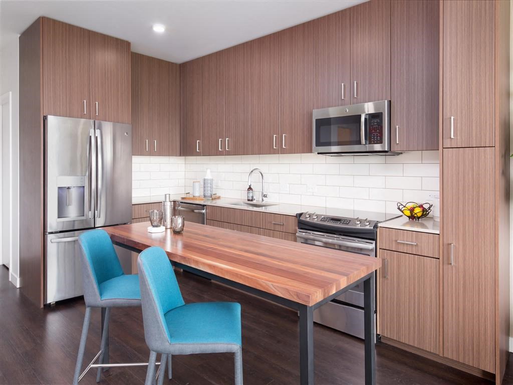 a kitchen with a wooden table and a refrigerator