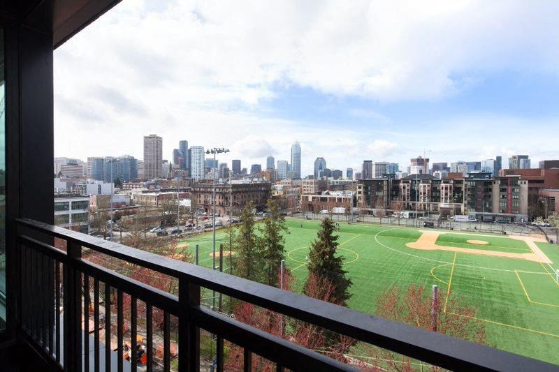 a balcony with a view of a soccer field and the city
