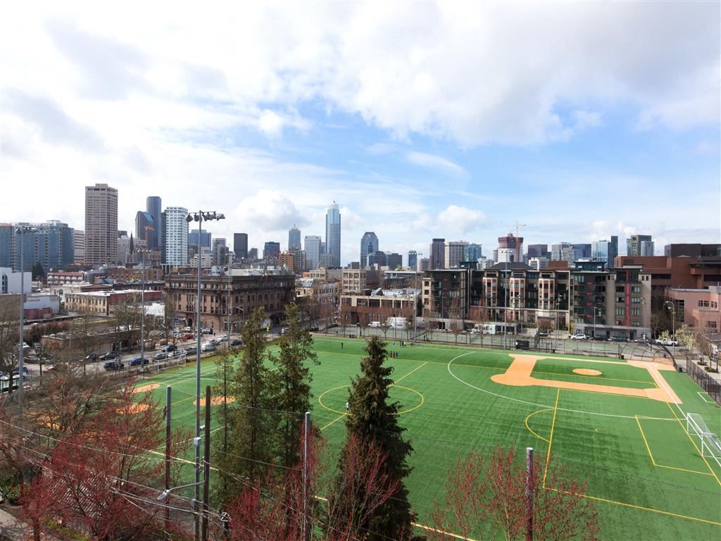 a soccer field with the city skyline in the background