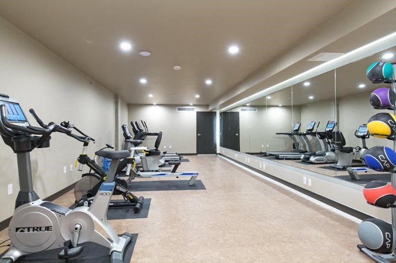 a gym with a bunch of exercise equipment and a mirror