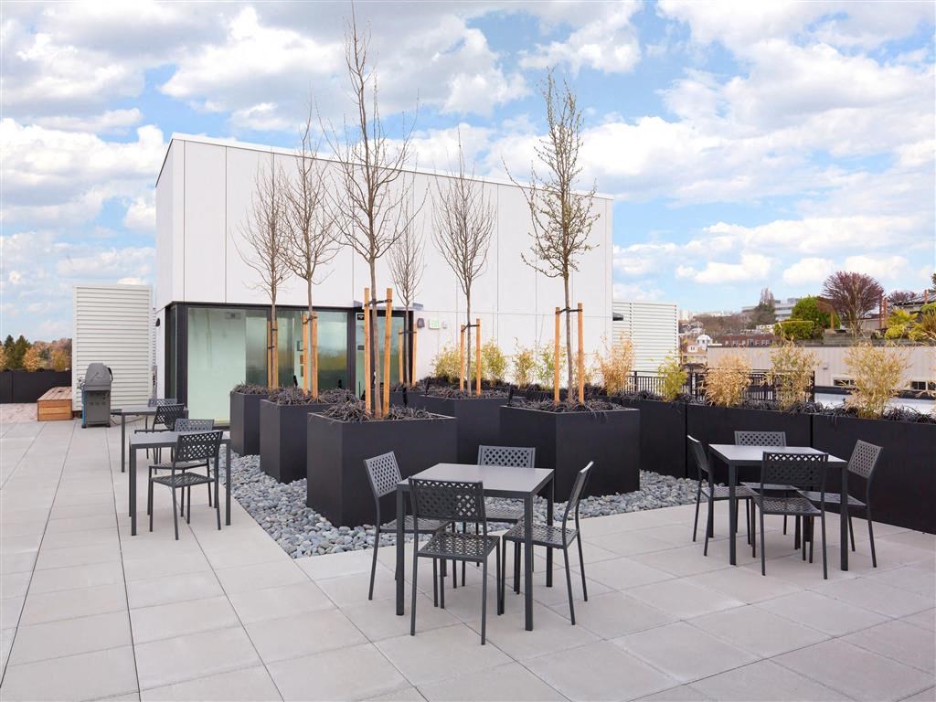 the patio of the building has tables and chairs