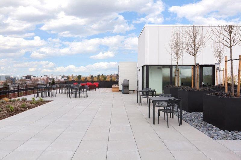 the patio of a building with tables and chairs