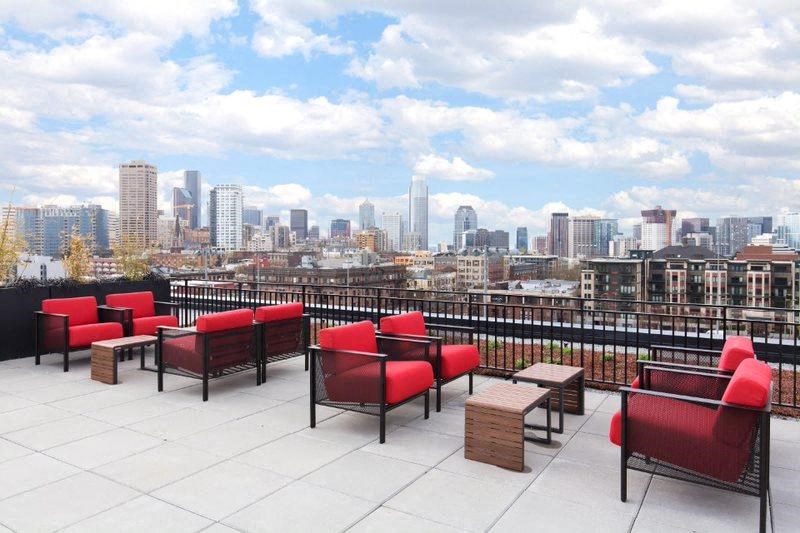 a view of the city from a roof top patio