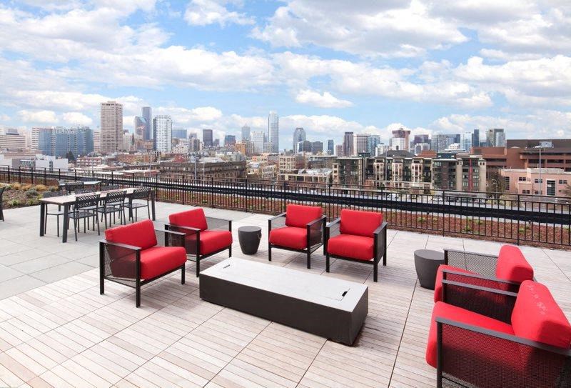 a view of the city from a roof top patio