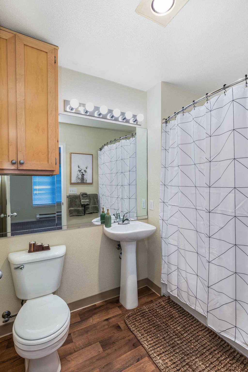 a bathroom with a toilet and a sink and a shower
