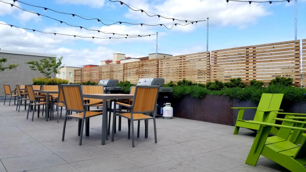 a patio with tables and chairs on a roof