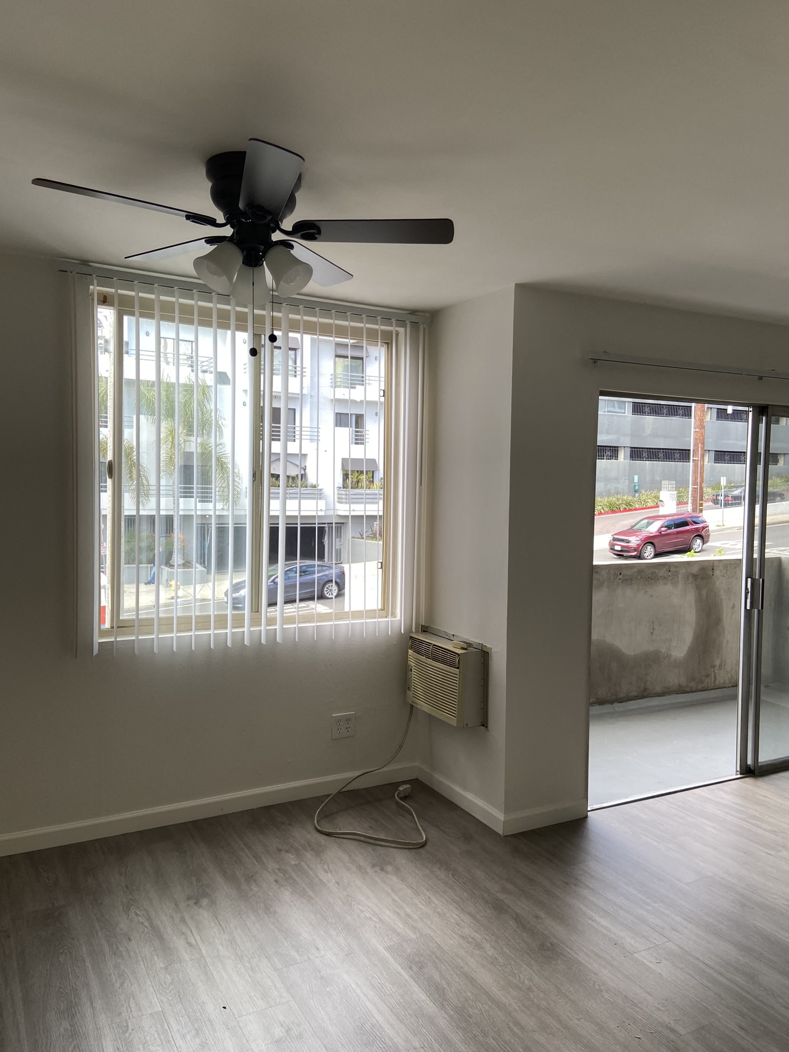 a living room with a ceiling fan and a window