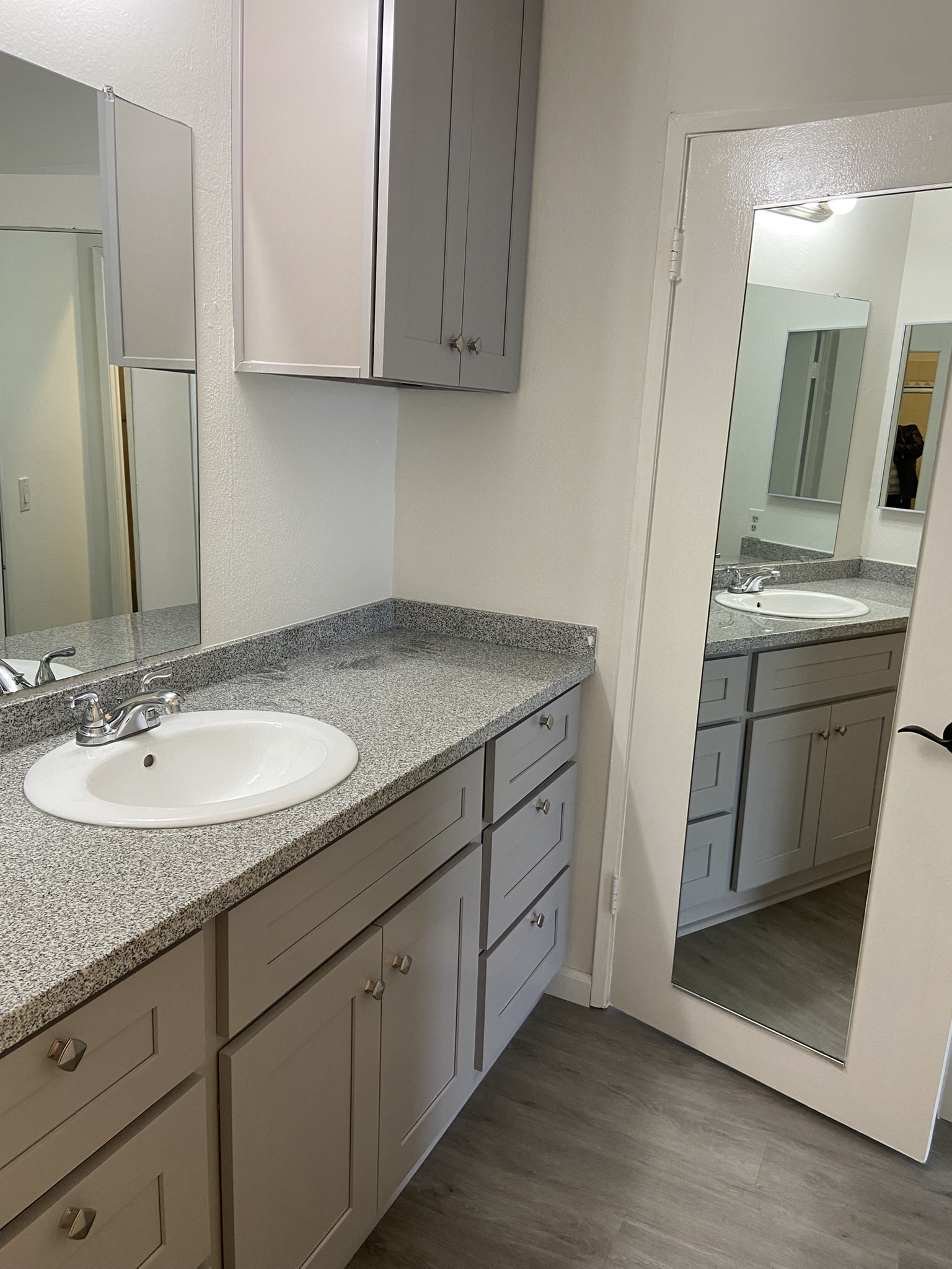 an empty bathroom with a sink and a mirror