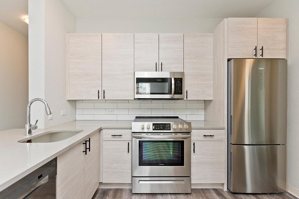 a kitchen with stainless steel appliances and white cabinets