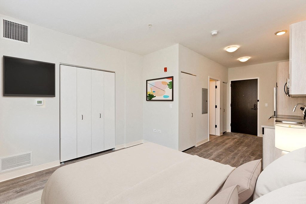 a bedroom with a bed and a tv