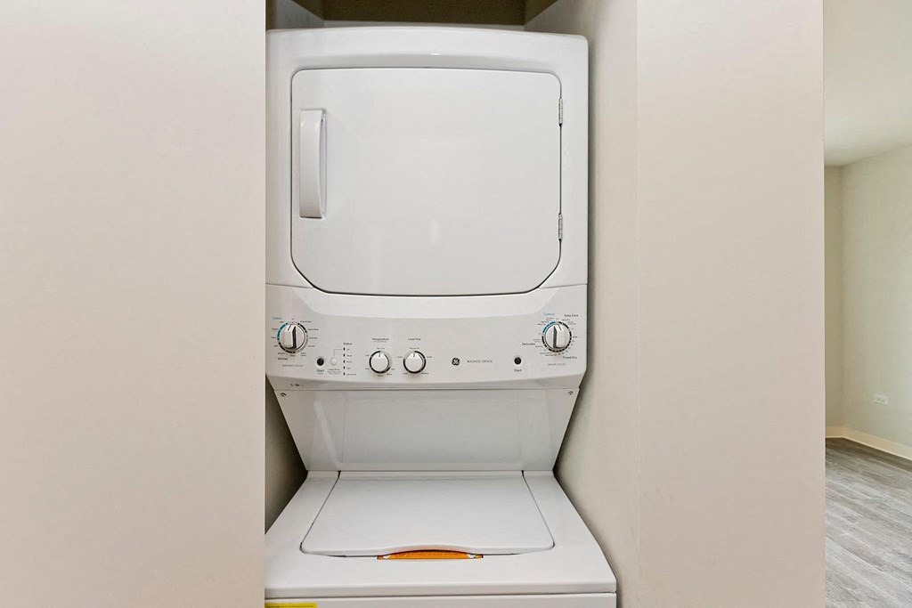 a white washer and dryer in a closet