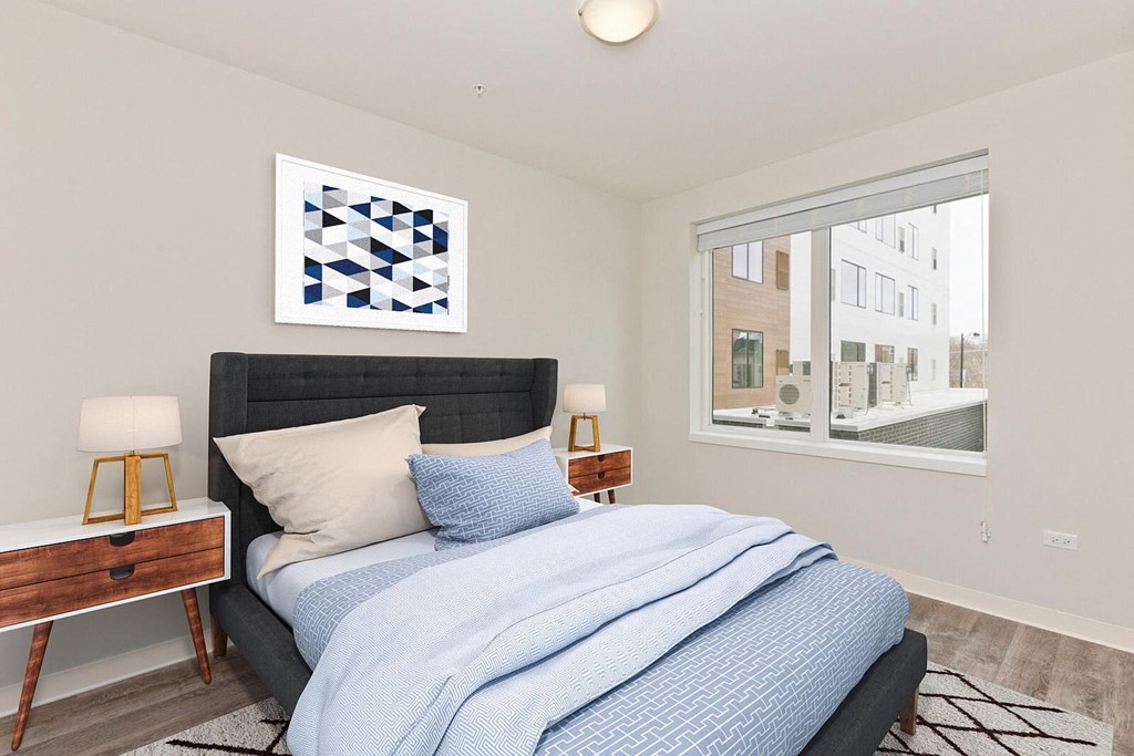 a bedroom with a bed and a large window