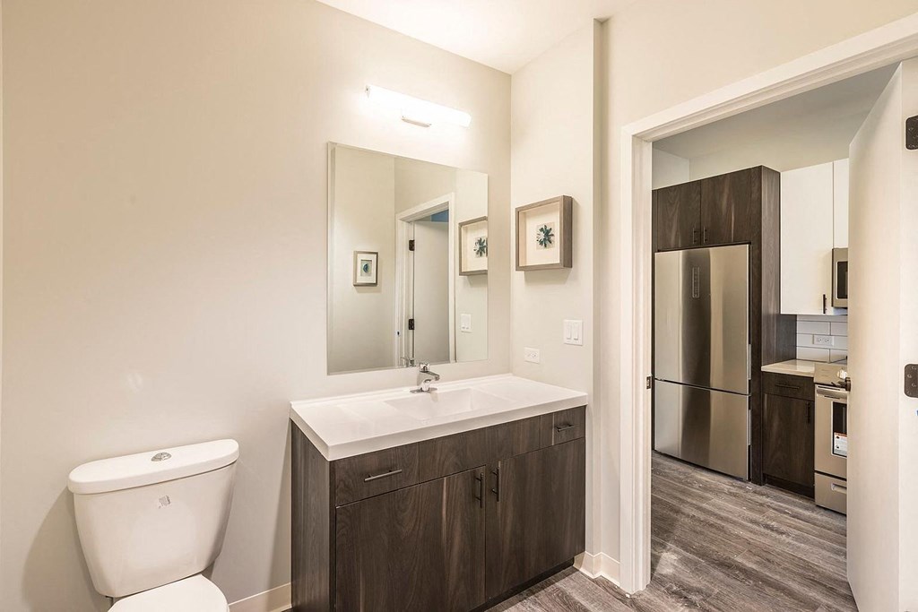 a bathroom with a toilet sink and a mirror