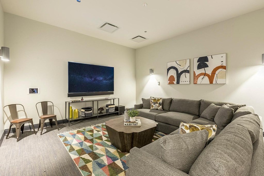 a living room with a large couch and a television