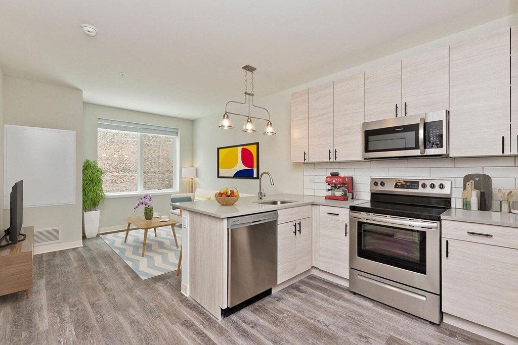 a kitchen with stainless steel appliances and white cabinets