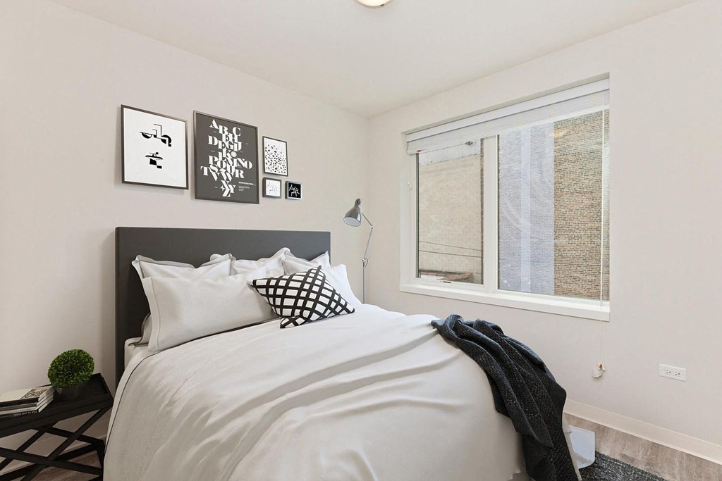 a bedroom with a large bed and a window