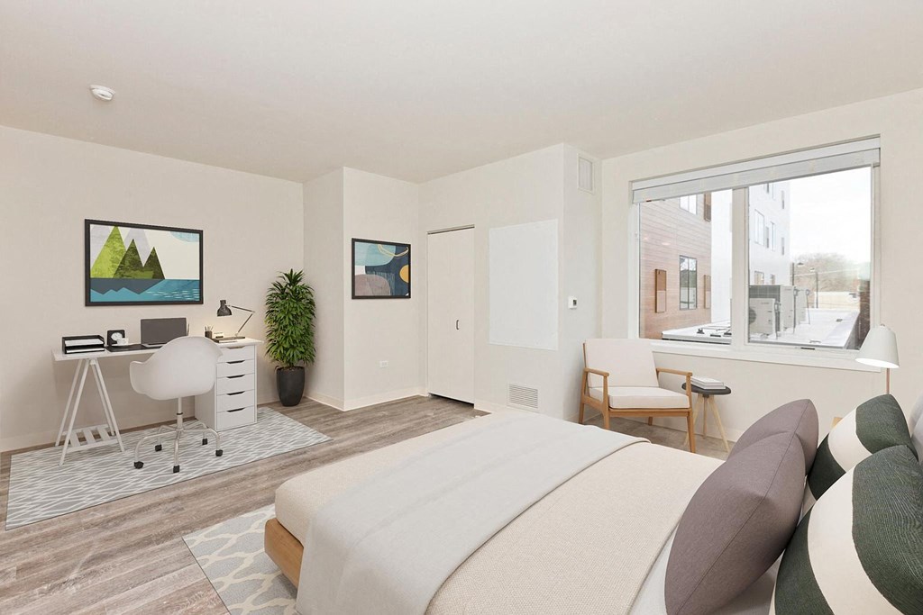 a bedroom with a bed and a desk and a window