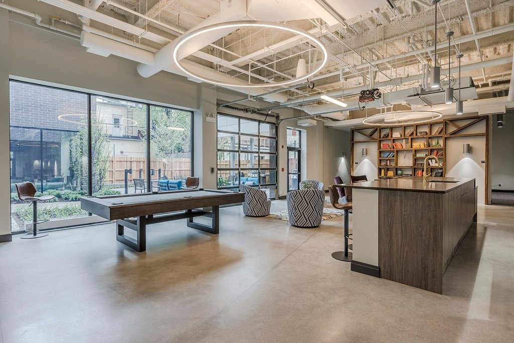 a large room with a ping pong table and a bar