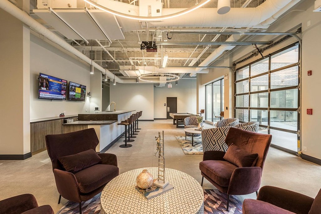 a lobby with couches and chairs and a bar