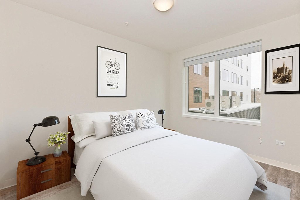 a bedroom with a bed and a window