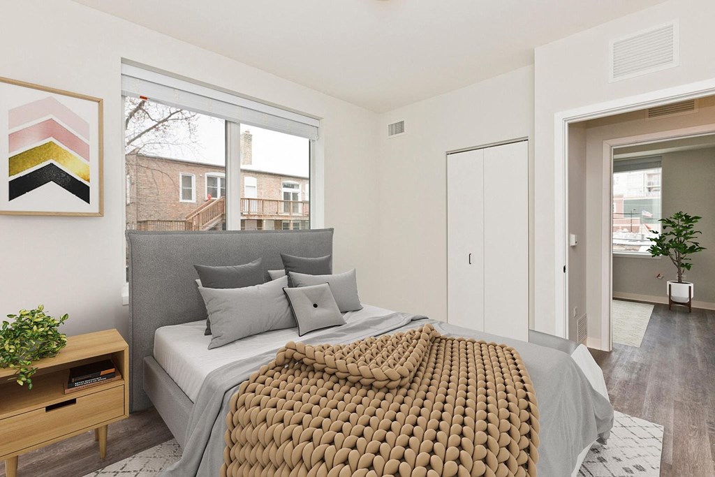a bedroom with a bed and a large window