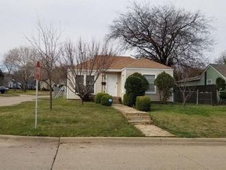 a white house on the corner of a street