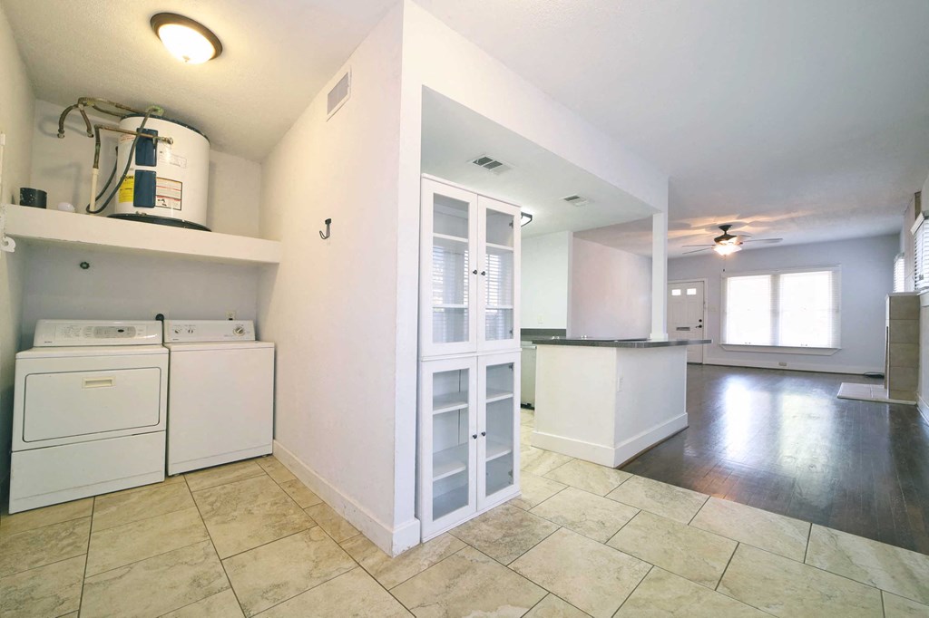 a laundry room with a washer and dryer and an open floor plan