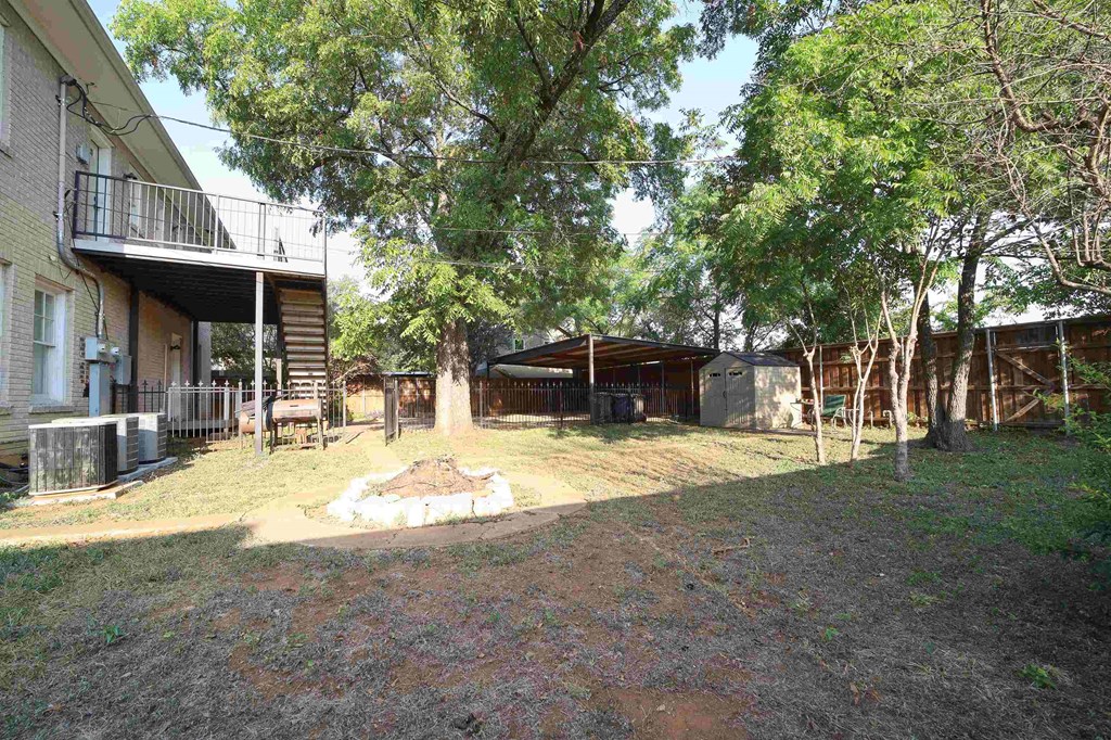 a backyard with a fire pit and a house