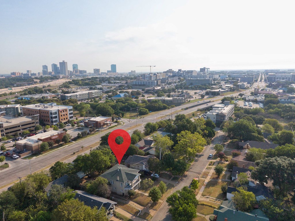 an aerial view of a city with a hot air balloon in the shape of a