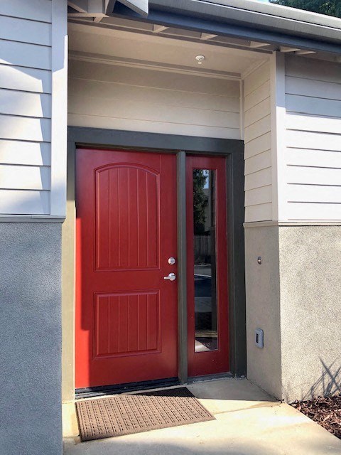 a red door on the side of a house