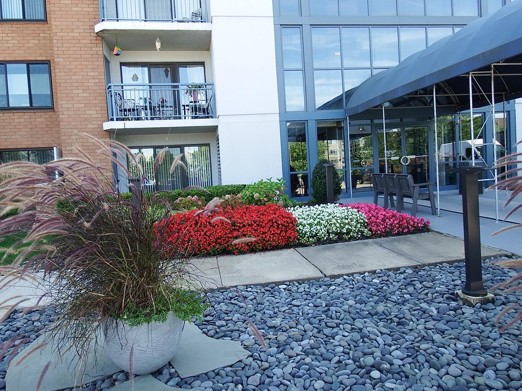 an outside view of a building with flowers and plants