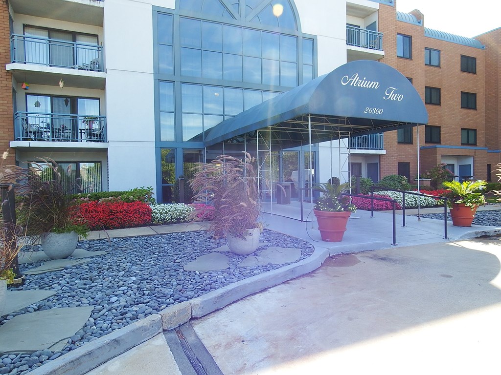 a building with an awning and plants in front of it