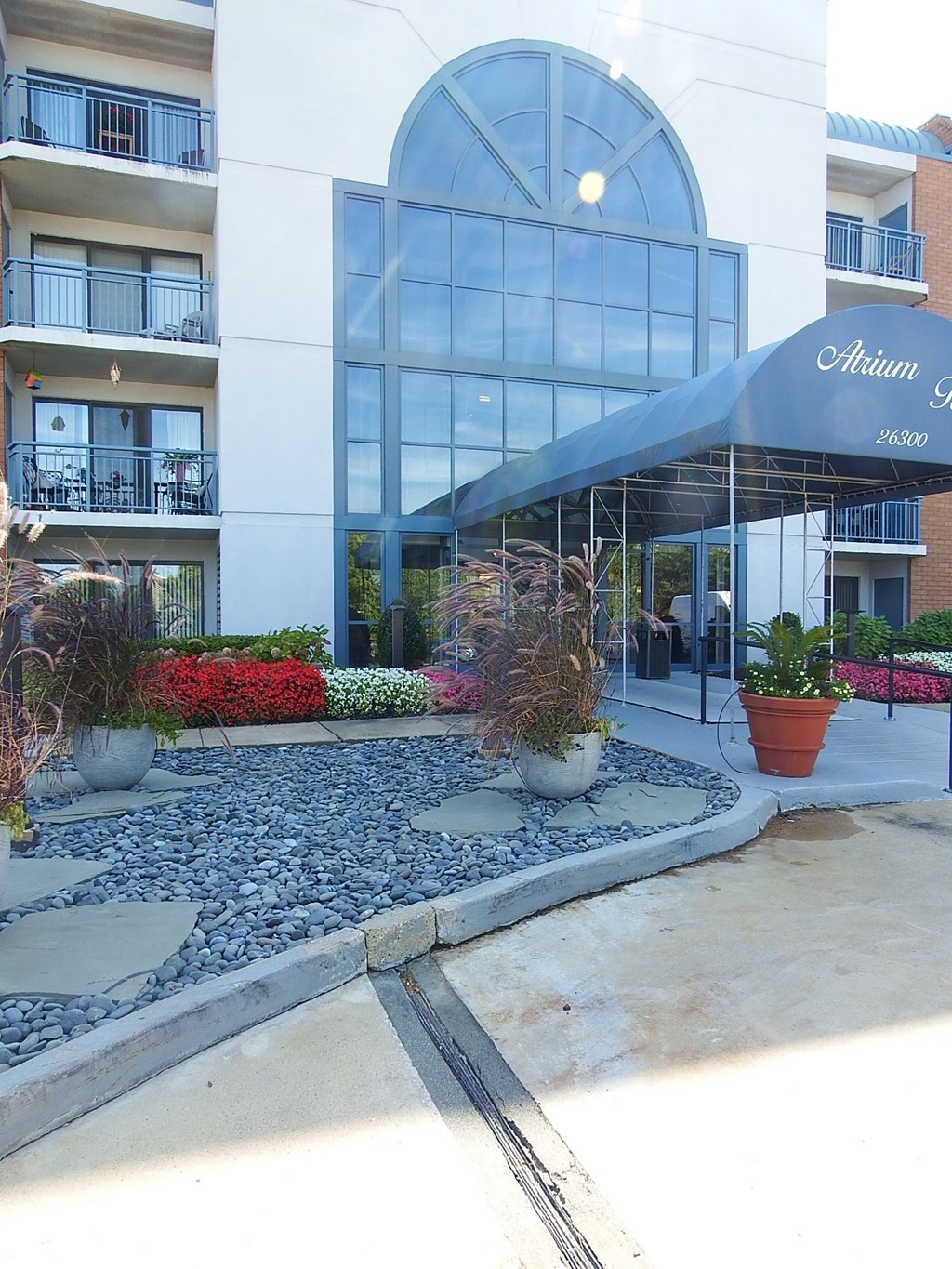 a view of the entrance to an apartment building with a blue awning