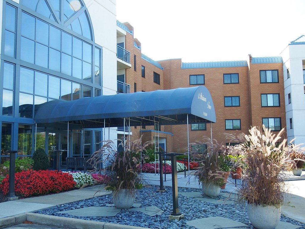 the front of a building with a blue awning