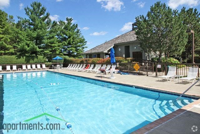 a large swimming pool with chairs around it