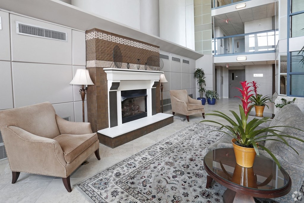 a living room with a fireplace and a table and chairs
