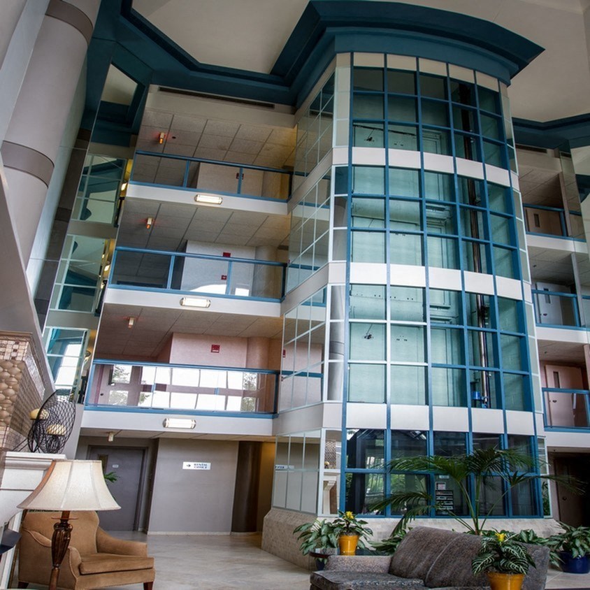 the lobby of an office building with large glass windows