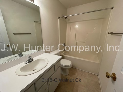 A bathroom with a sink, toilet, and bathtub.