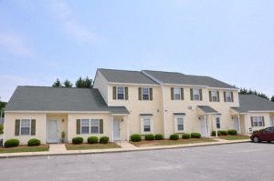 a large house with a red car parked in front of it