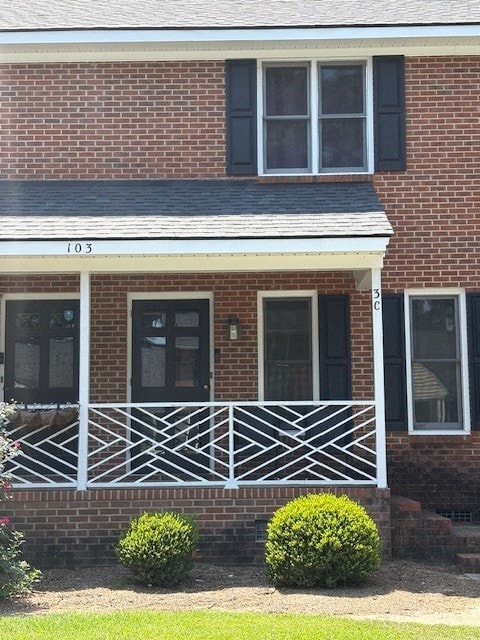 House number 103 has a black front door and a white porch.