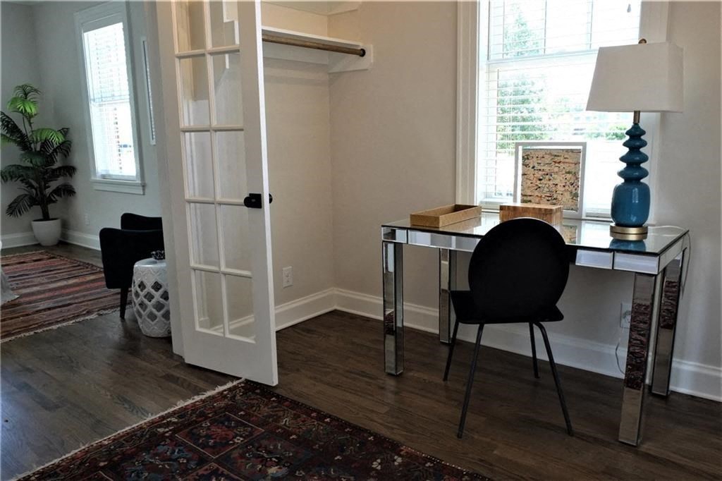 a home office with a desk and a window