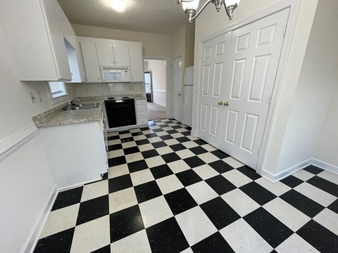A black and white checkered floor in a kitchen.