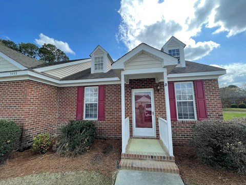 A house with a red door and red shutters.
