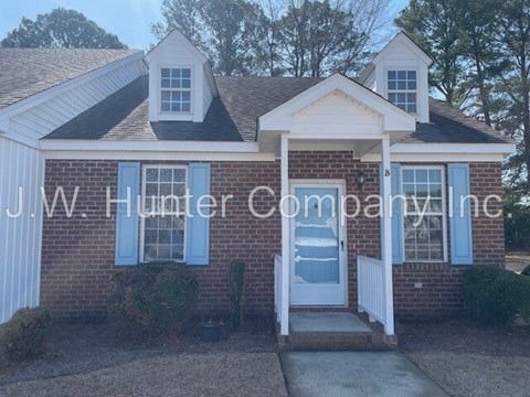 A brick house with the name J.W. Hunter Company Inc written on it.