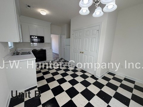 A black and white checkered floor in a white room.