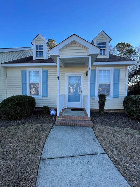 A house with a blue door and a small porch.