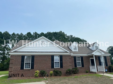 A brick house with the words Unit A on the front.