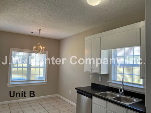 A kitchen with a sink and a window.