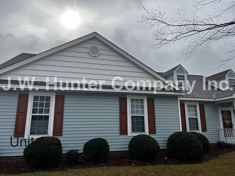 A house with the sign "J.W. Hunter Company Inc." on it.