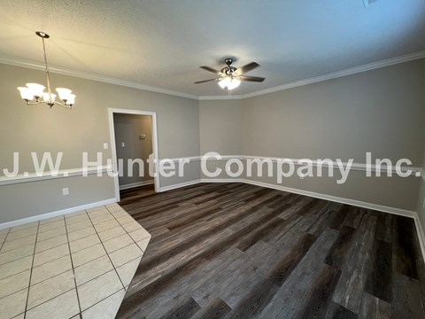 A room with wooden flooring and a ceiling fan.